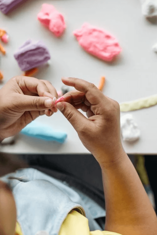 Child rolling a strand of play dough