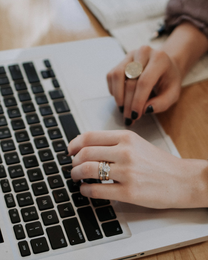 Hands typing on a laptop, purchasing a gift card online