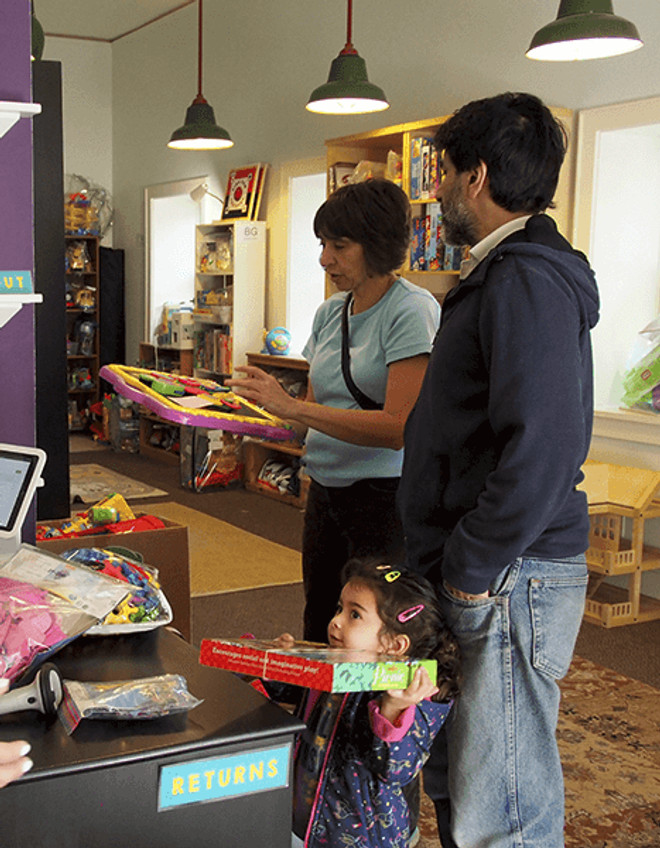 A family checking out toys at the toy library